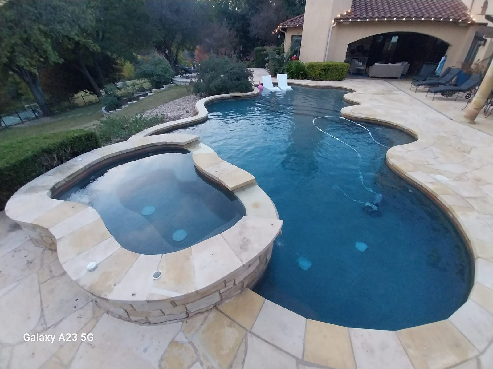 Clean backyard residential pool maintained by The Pool Police — Lakeway TX